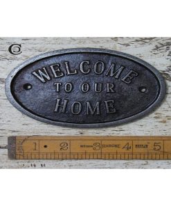 PLAQUE OVAL WELCOME TO OUR HOME CAST ANT IRON 90 X 133MM