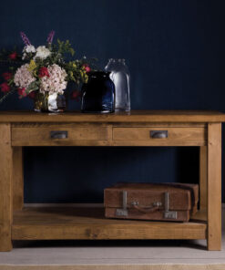 Rustic plank consoe table , with a bunch of flowers placed on top.